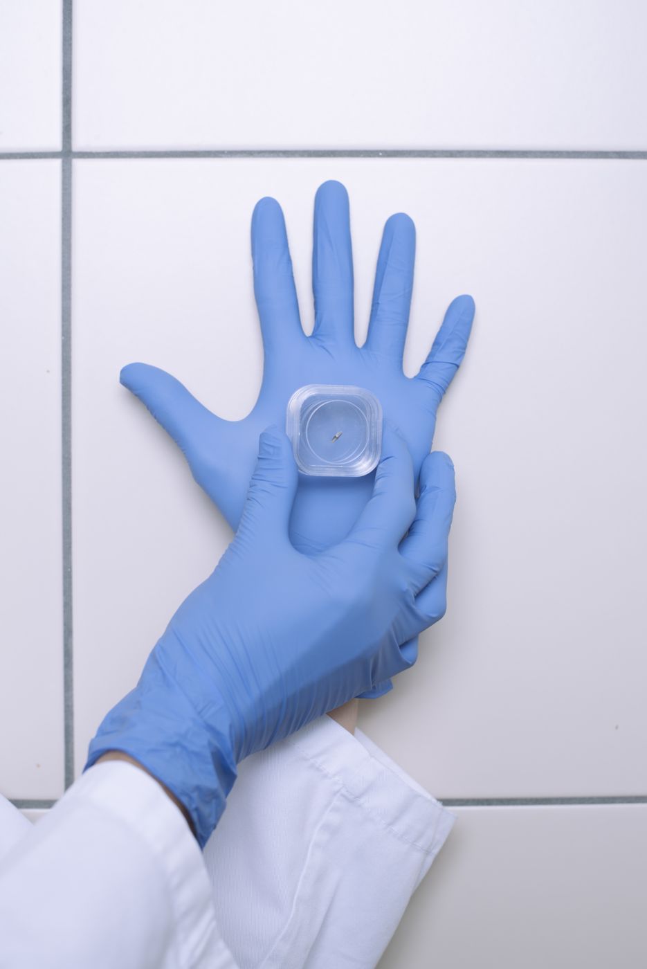 A Choice valve held on a gloved palm in the lab