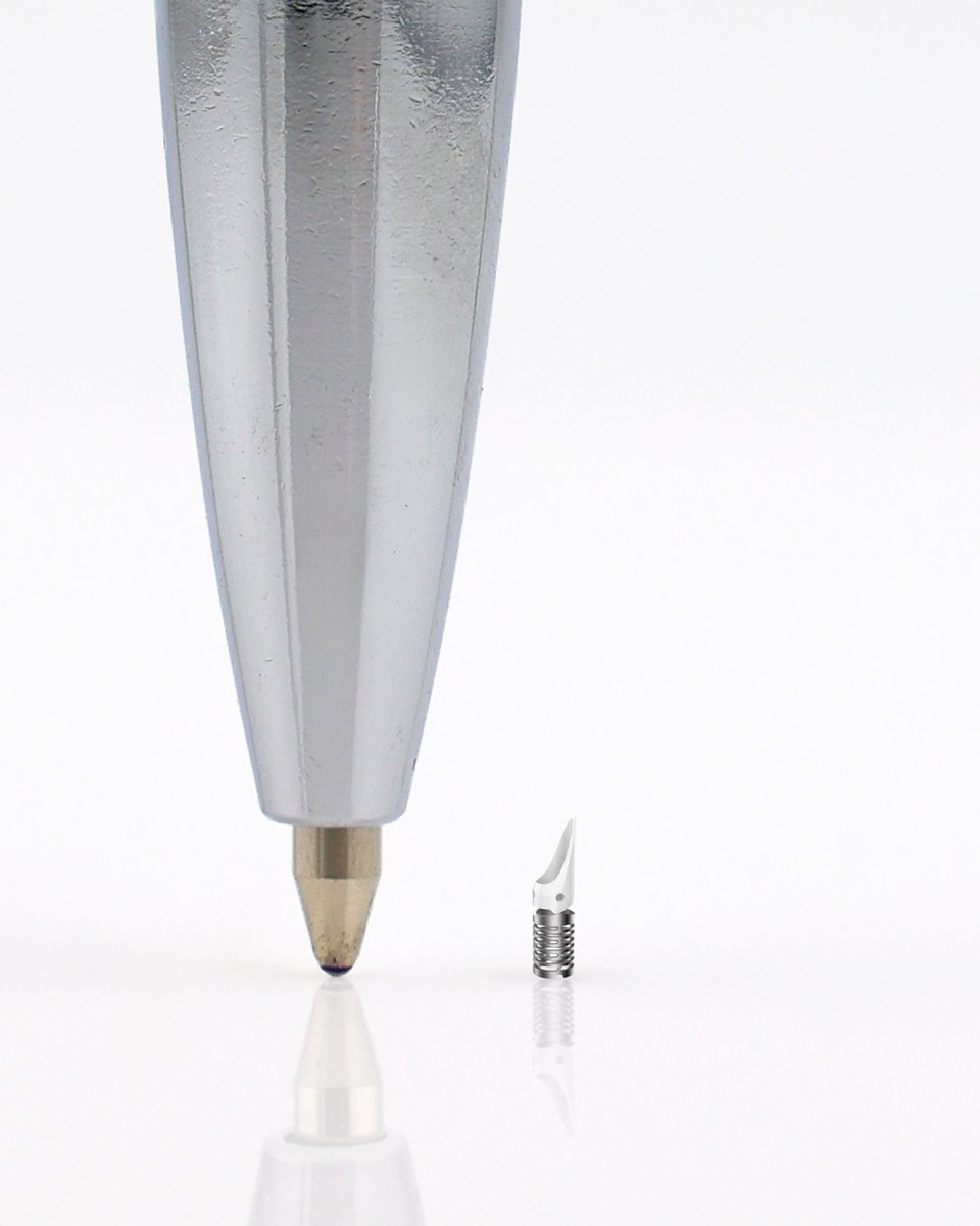 The Choice valve next to the tip of a ballpoint pen